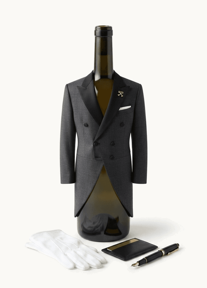 A wine bottle wearing a tailored coat, styled like a concierge